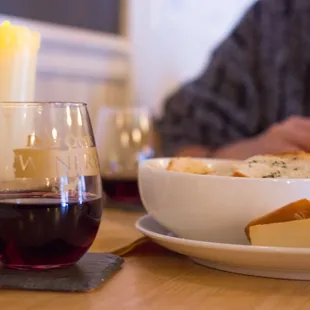 a woman eating cheese and wine
