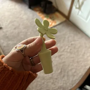 a hand holding a bottle of wine