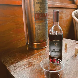 a bottle of wine and a glass of wine