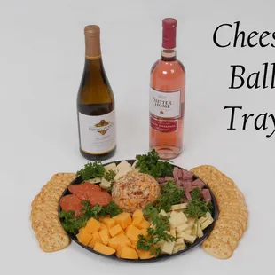 a cheese ball tray and a bottle of wine