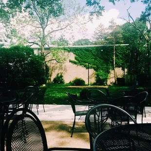 a patio with tables and chairs