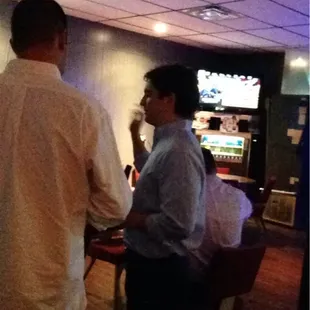 two men sitting at a bar