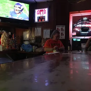 two people sitting at a bar