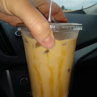 a hand holding a cup of coffee