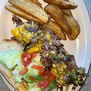 Philly cheesesteak sub with potato wedges