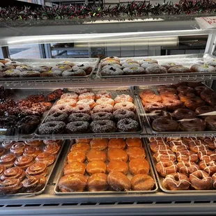 a variety of donuts in a display case