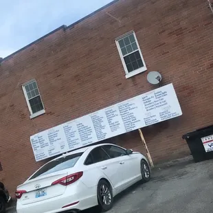 a white car parked in front of a building