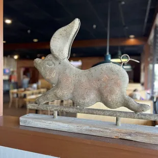 a sculpture of a rabbit running