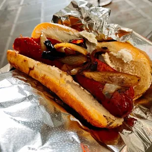 a hot dog on a bun with toppings