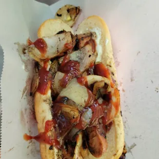 a hot dog with onions and ketchup