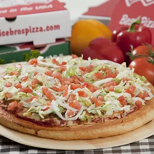 a pizza with tomatoes and lettuce