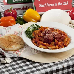 a plate of pasta with meat and vegetables