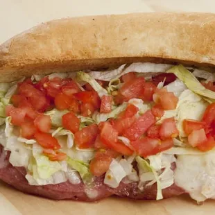 a sandwich with tomatoes and lettuce