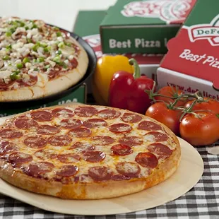 two pizzas on a table