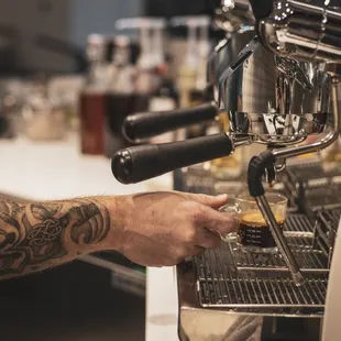 a bari preparing a cup of coffee