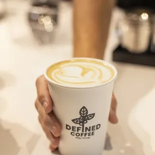 a person holding a cup of coffee