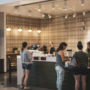 a group of people standing at a counter