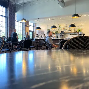 people sitting at tables in a coffee shop