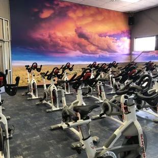 The newly renovated cycling room at Defined Fitness Riverside! Brand new cycle bikes, flooring and wall graphic.