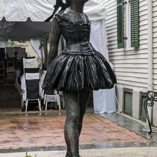 Statue with courtyard and wedding set up in background