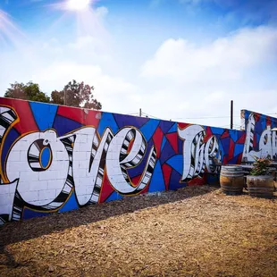a colorful wall with graffiti on it