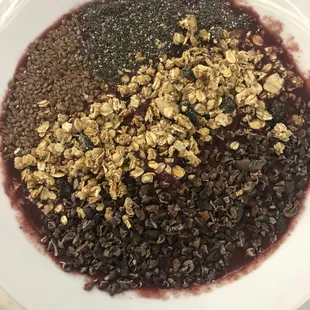 Acai bowl with flax seed, chia seed, granola and chocolate flakes