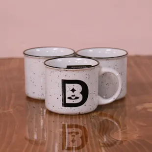 three coffee mugs on a wooden table