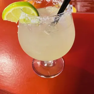 Margarita with salt rim and lime garnish
