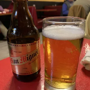 a glass of beer and a bottle of beer