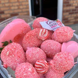 a person holding a basket of donuts