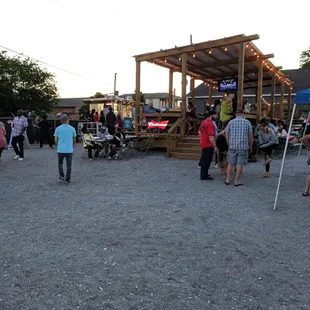 a crowd of people standing and sitting