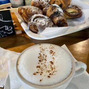 a cup of cappuccino and pastries