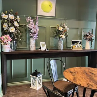 a table with flowers and vases on it
