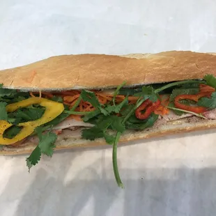 a sub sandwich with meat and vegetables