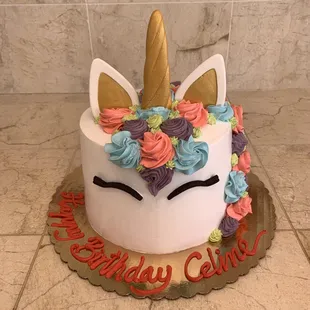a birthday cake with a unicorn face