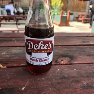 a bottle on a picnic table