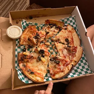 Gluten free pizza with cheese sausage, olives, pineapple