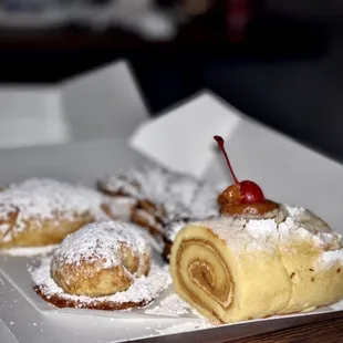 Pineapple cream cheese, guava cream cheese, apple roll with cherry, chocolate croissant.