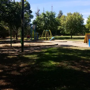 Play structure, toddler swings, and a mini walk wall. Along with a giant open field.