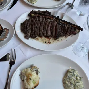 Tomahawk, loaded baked potato, creamed spinach