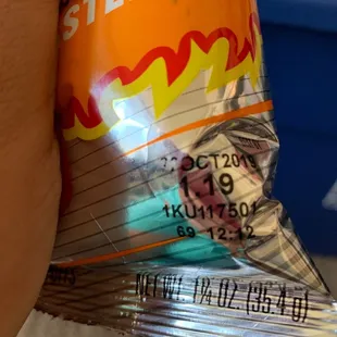 a hand holding a bag of del lago