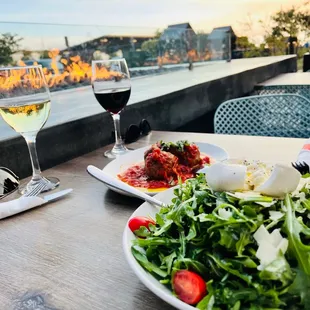 Outdoor dining. Burrata salad and meatball plate.