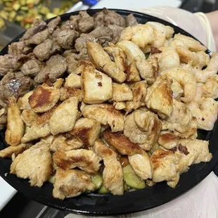 Hibachi Trio Plate! Chicken, Steak, and Shrimp with veggies underneath on a bed of fried rice