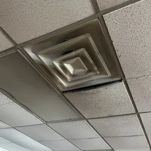 Extensive black mold in the ceiling and air vent of the group exercise room.