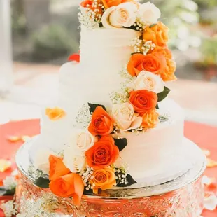 Our wedding cake designed by Lucy with fresh flowers on top. She will loan you the cake platter for free!