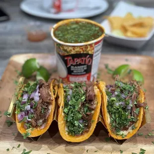 three tacos on a cutting board