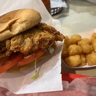 a fried chicken sandwich and tater tots