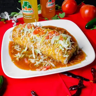 a plate of enchiladas on a red cloth