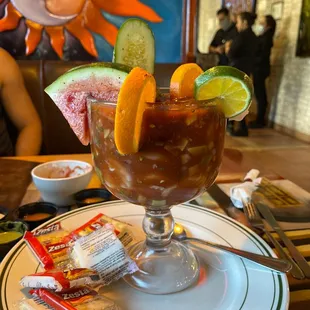 a bloody drink with a slice of watermelon