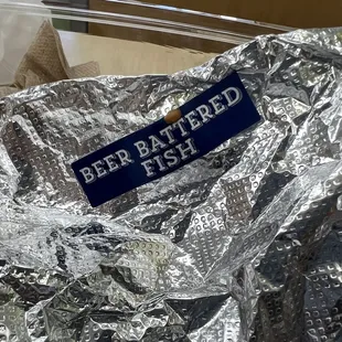 a sign that reads beer battered fish